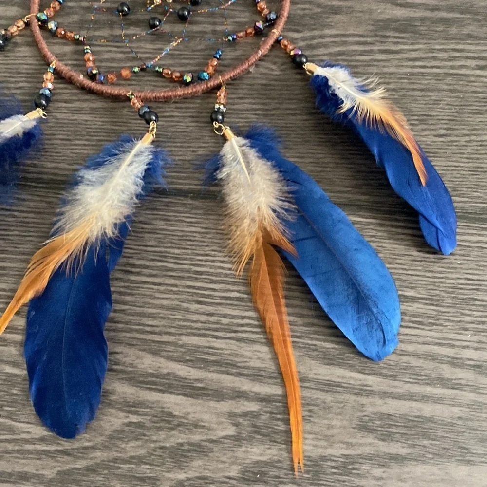 Dream catcher. Blue and tan feathers beaded. Beautiful!